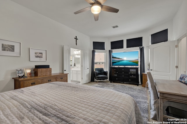 carpeted bedroom with ceiling fan and connected bathroom