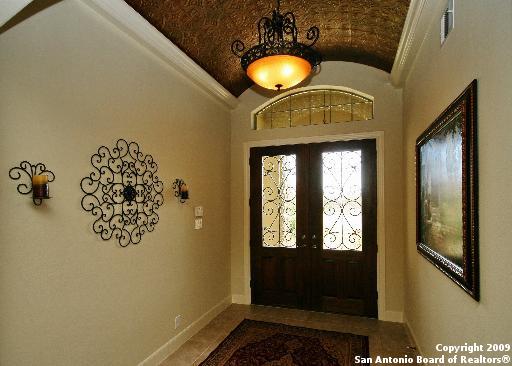 entrance foyer with vaulted ceiling and french doors