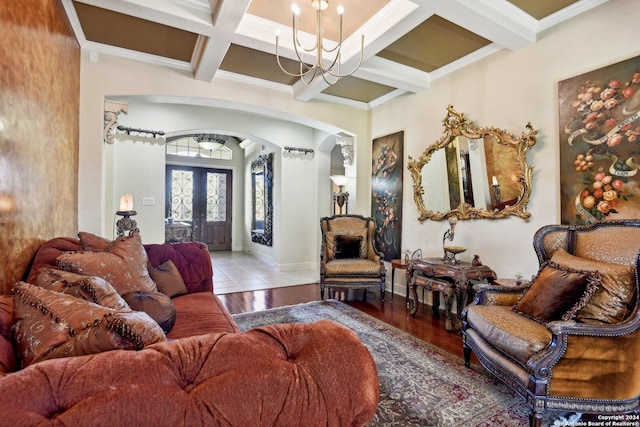 315 Dona Ana Cv, Helotes, TX 78023 - living room featuring arched walkways, a chandelier, french doors, wood finished floors, and beamed ceiling