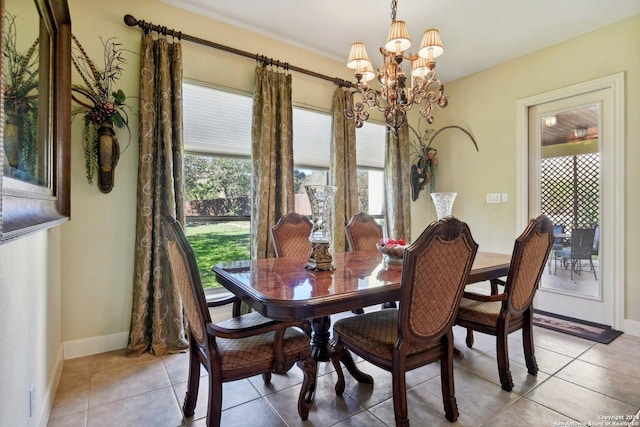 dining room featuring light tile patterned floors, a wealth of natural light, and a chandelier