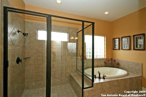 bathroom with separate shower and tub and a wealth of natural light