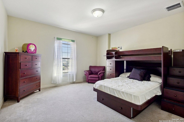 bedroom featuring light carpet