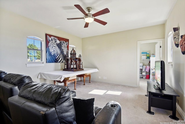 living room featuring ceiling fan and light colored carpet