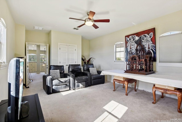 carpeted living room featuring ceiling fan