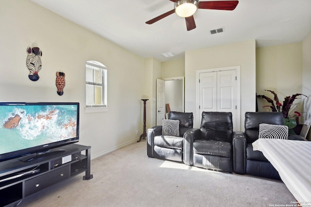 carpeted cinema room with ceiling fan