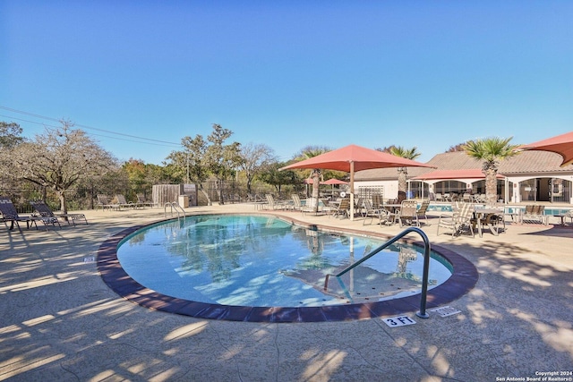 view of swimming pool featuring a patio area