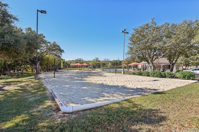 view of home's community featuring a lawn and volleyball court