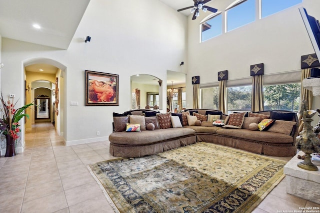 315 Dona Ana Cv, Helotes, TX 78023 - living room with arched walkways, ceiling fan, light tile patterned floors, a high ceiling, and recessed lighting