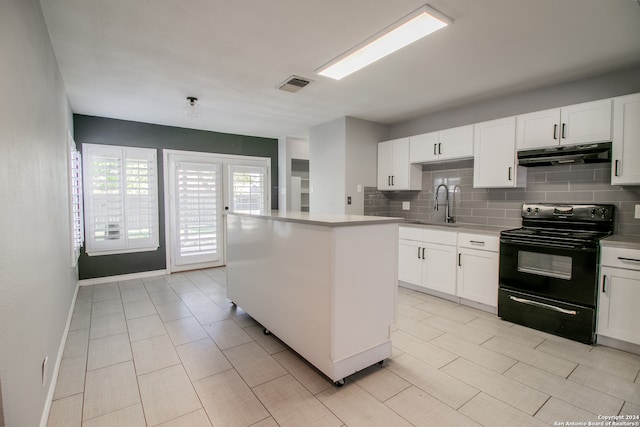 kitchen featuring white cabinets, a kitchen island, tasteful backsplash, and black / electric stove