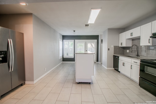 kitchen featuring sink, tasteful backsplash, ventilation hood, white cabinets, and black appliances