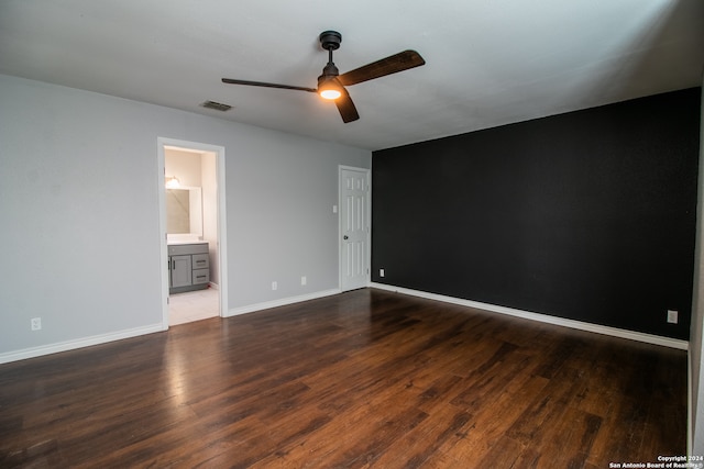 empty room with dark hardwood / wood-style flooring and ceiling fan