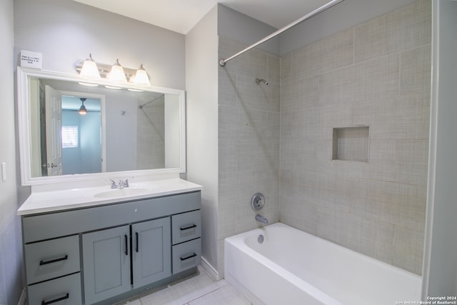 bathroom with tile patterned flooring, vanity, and tiled shower / bath combo