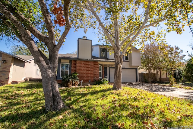 view of front of property with a garage and a front lawn