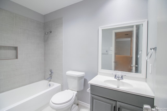 full bathroom featuring vanity, toilet, and tiled shower / bath combo