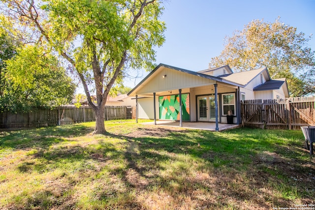 rear view of property with a lawn, french doors, and a patio