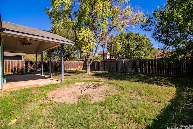 view of yard with ceiling fan and a patio