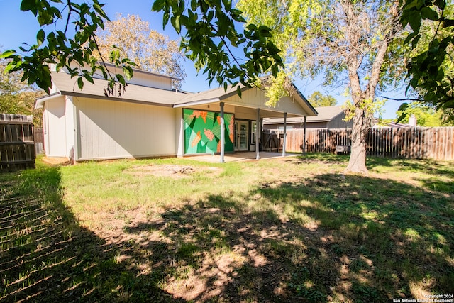 rear view of property featuring a yard