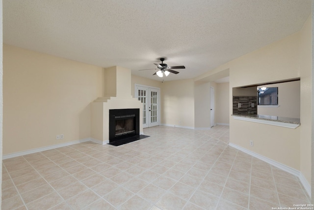 unfurnished living room featuring french doors, a textured ceiling, and ceiling fan