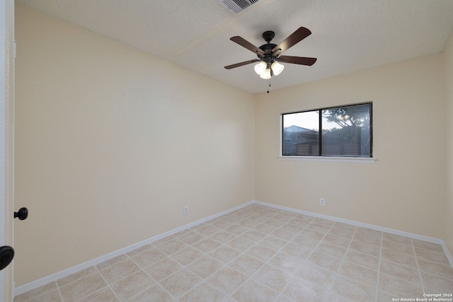 empty room featuring ceiling fan and a textured ceiling