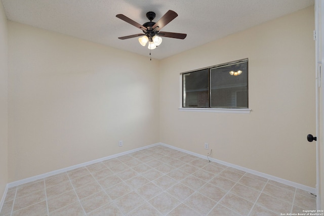 empty room featuring ceiling fan and a textured ceiling