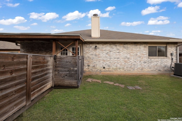 rear view of property with a lawn