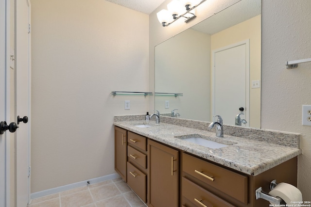 bathroom featuring tile patterned floors, vanity, and a textured ceiling