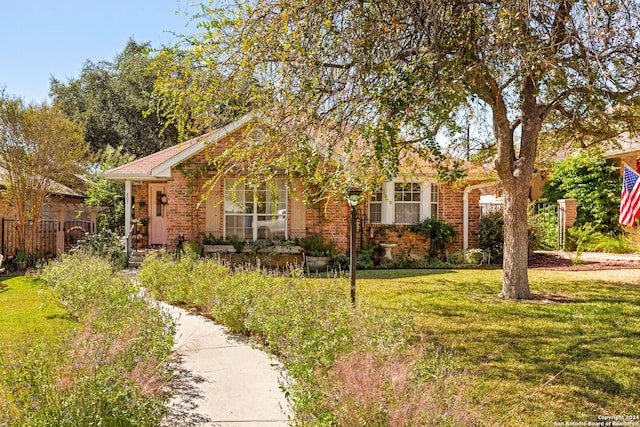 obstructed view of property featuring a front yard