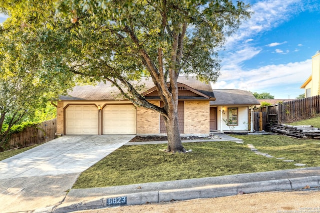 view of front of home featuring a garage and a front lawn