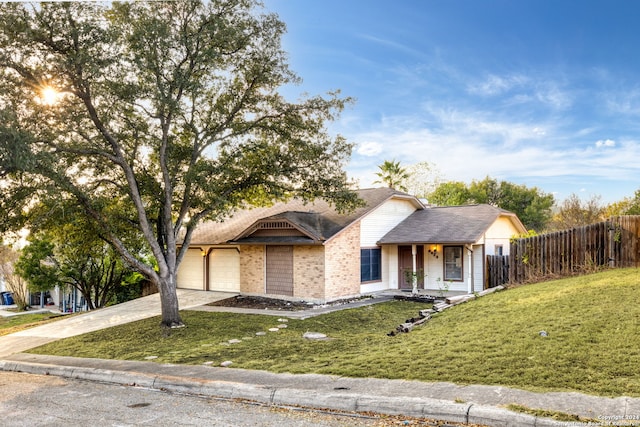 view of front of property with a front yard and a garage