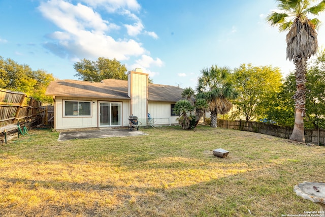 back of property featuring a yard