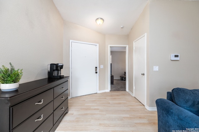 corridor with light hardwood / wood-style flooring