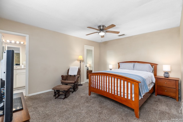 bedroom with carpet, ensuite bathroom, ceiling fan, and a textured ceiling