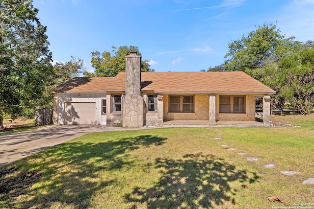 ranch-style house featuring covered porch, a garage, and a front lawn