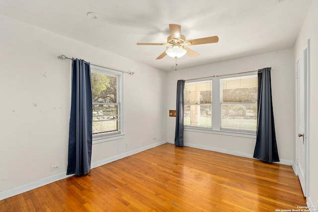 spare room with ceiling fan and wood-type flooring