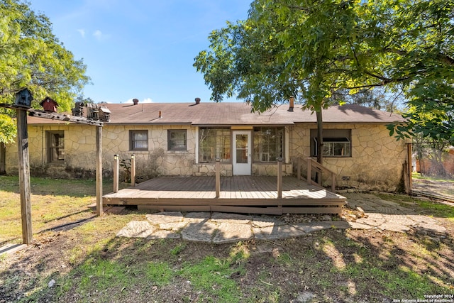 rear view of property with a wooden deck