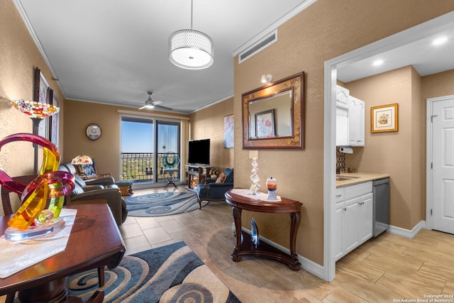 living room with ceiling fan and crown molding