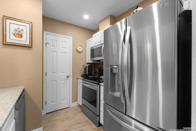 kitchen featuring appliances with stainless steel finishes and white cabinetry