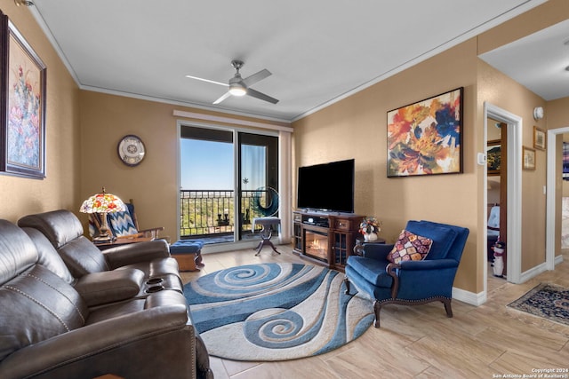 living room featuring ceiling fan, a fireplace, and crown molding