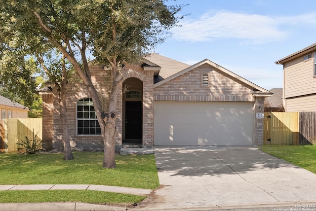 view of front of property featuring a front yard and a garage