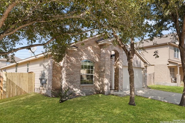 view of front of property with a front yard and a garage