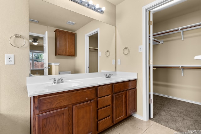 bathroom featuring tile patterned floors, vanity, ceiling fan, and toilet