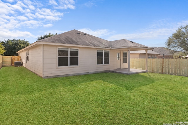 back of property featuring central AC, a yard, and a patio