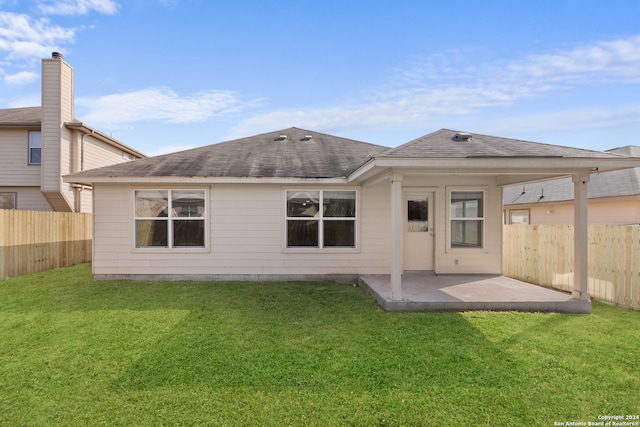 back of property featuring a yard and a patio