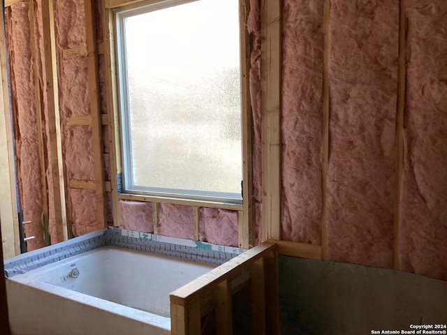 bathroom with a tub to relax in