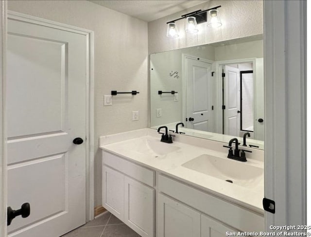 bathroom featuring tile patterned flooring and vanity