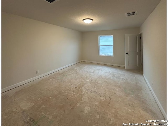 unfurnished room featuring a textured ceiling