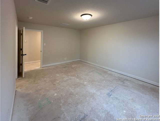 unfurnished room featuring a textured ceiling