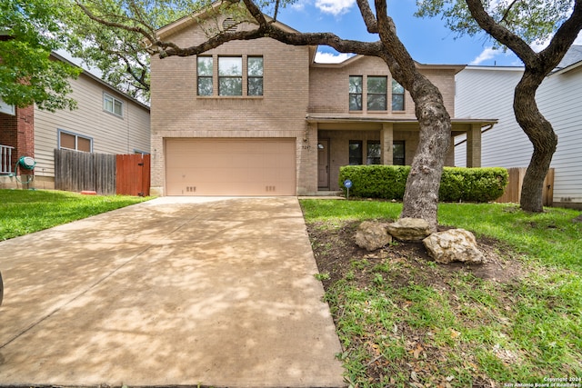 view of front of property featuring a garage and a front yard