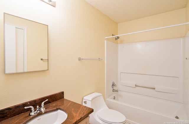 full bathroom featuring vanity, toilet, tub / shower combination, and a textured ceiling