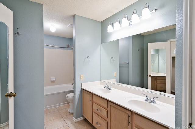 full bathroom with toilet, a textured ceiling, tile patterned flooring, shower / bathtub combination, and vanity